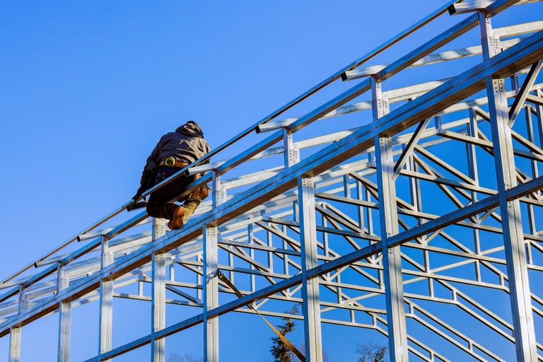 Construction worker assembling framework metal structure